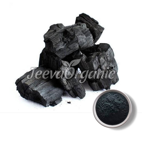 A stack of black charcoal pieces alongside a bowl of powdered charcoal, highlighting natural organic materials.
