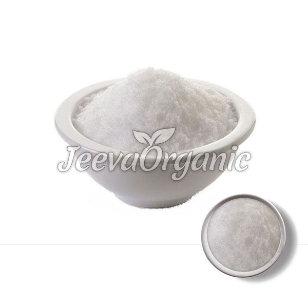 A white bowl filled with fine, crystalline salt sits on a plain background, showcasing its pure texture and organic branding.