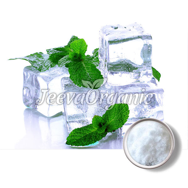 A pile of clear ice cubes topped with fresh mint leaves, with a small bowl of white powder beside them.