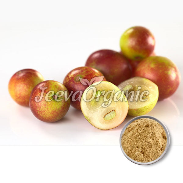 A collection of small, round, colorful fruits with smooth skin, accompanied by a bowl of brown spice powder on a white background.