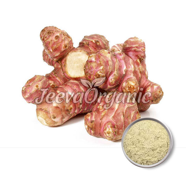 A cluster of fresh, pinkish-purple tubers with a white interior, beside a small bowl of powdered form, labeled "Jeeva Organic."