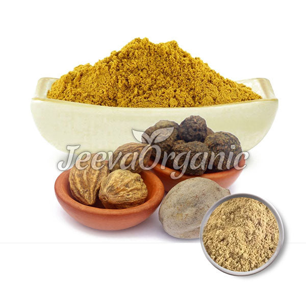 A bowl of yellow spice powder surrounded by whole spices and seeds, showcasing organic ingredients for culinary uses.