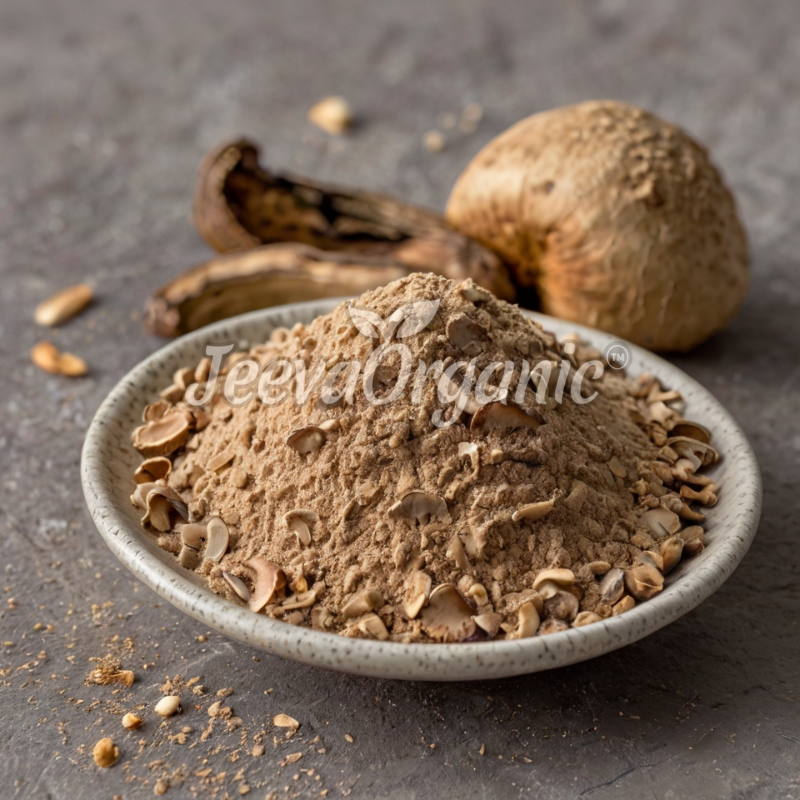 A small bowl filled with golden-brown powder and flakes, with dried bananas and mushrooms in the background.