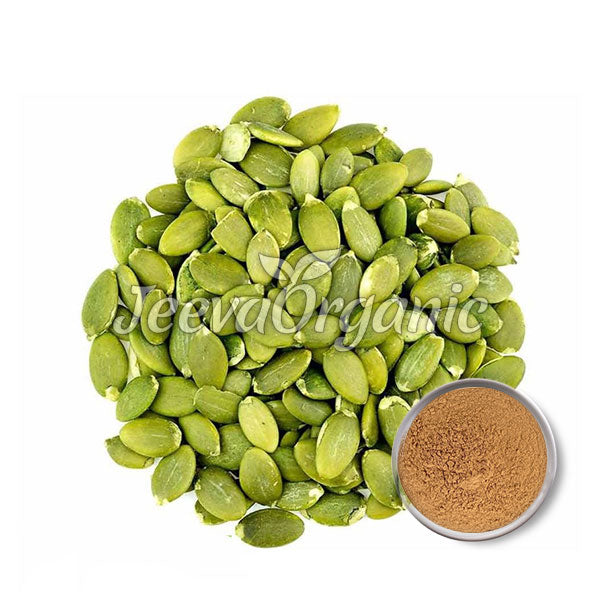 A pile of green pumpkin seeds with a small bowl of pumpkin seed powder beside them, arranged on a white background.