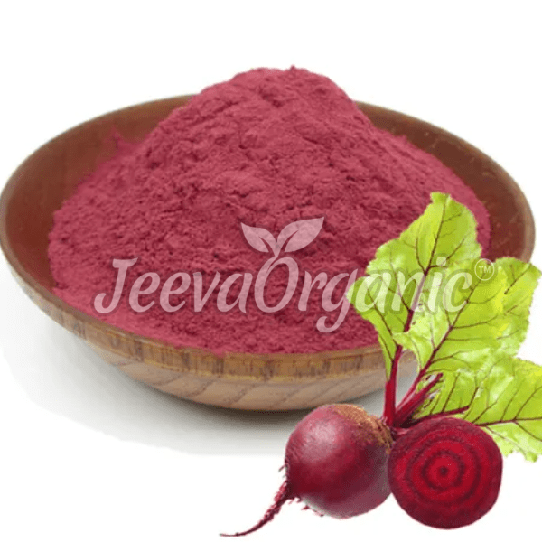 A bowl filled with vibrant pink beetroot powder, accompanied by fresh beetroot and green leaves, showcasing its organic origin.