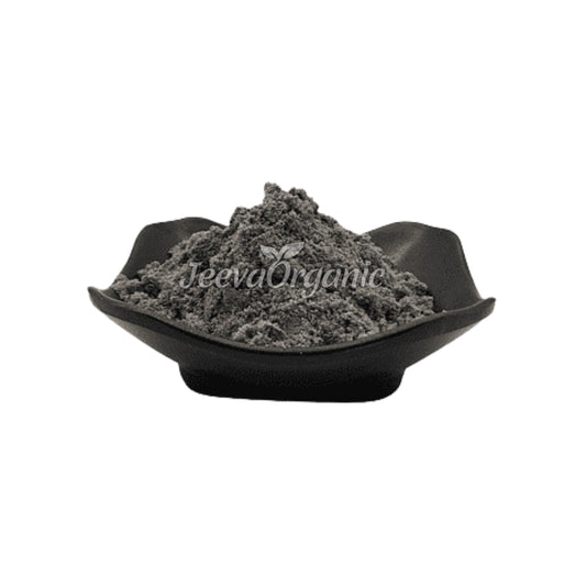 A mound of gray organic powder in a black dish, labeled with "Jeeva Organic" logo against a white background.