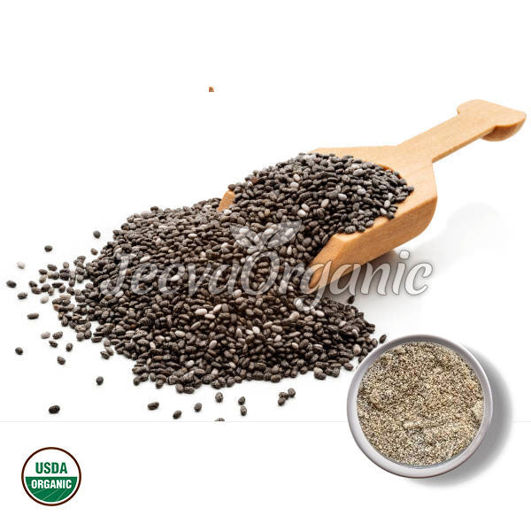 A wooden scoop spilling organic black chia seeds, with a small bowl of ground chia seeds beside it. USDA Organic label visible.