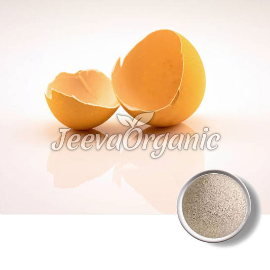 Two cracked egg shells with a small bowl of white powder beneath them, showcasing organic products with a clean, minimalist background.