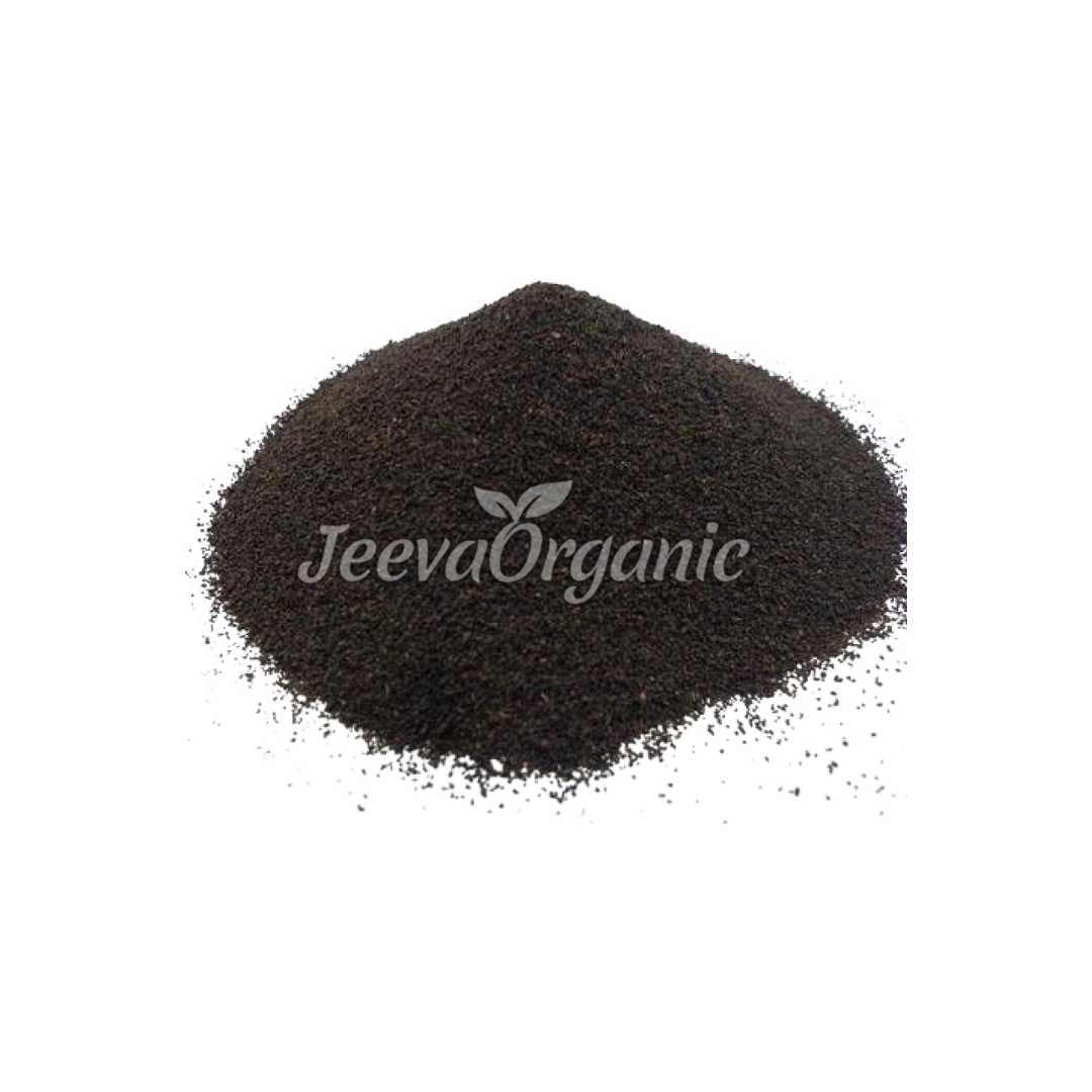 A container of fine, dark brown powder made from organic black tea leaves, suitable for brewing or use in culinary applications.