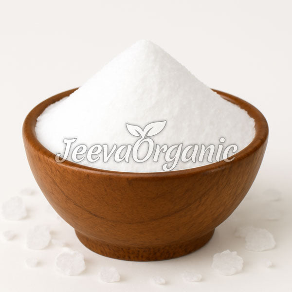 A wooden bowl filled with Potassium Chloride Powder, showcasing a small mound and scattered salt crystals around it.
